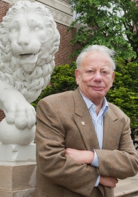 Sigmund Rolat posing in front of Mick and Mack on campus.