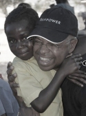 Jean-Robert Cadet hugging a restavek child.