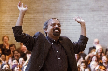 UC graduate and music composer Kanniks Kannikeswaran conducts a choral concert