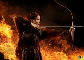 Katniss shooting a bow and arrow.