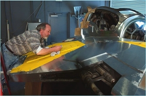 Charlie Bailey painting on a Jedi starfighter