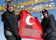 Marc Scheineson holds up a Bearcart flag, with assistance from his British colleague.