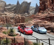 Two cars driving through the canyon of Cars Land