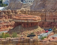 Two cars drive through the canyon lands