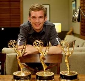 Travis Hagenbuch poses with all three of his Emmy statues.