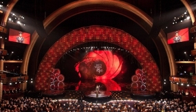 Overview of the stage at the 2013 Academy Awards, bathed in a red light.