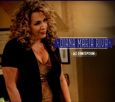 Diana Maria Riva in a shot from the show, also showing a little cleavage.