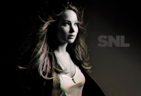 With her hair blowing, Jennifer Lawrence poses for a SNL promo shot in black and white.