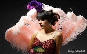 Zooey decked out in feathers, and with her hair sophiticatedly on top of her head.