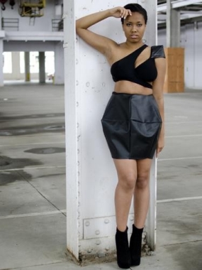 Asha outfit includes a midriff-baring mini made out of black leather-type fabric