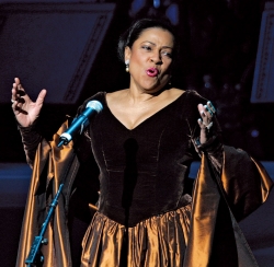Kathleen Battle singing, wearing a satin and velvet gown