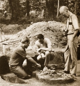 Gustav Carlson examines the findings of a student dig.