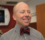 University of Cincinnati basketball coach Mick Cronin sports the new UC bowtie design.