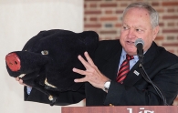 University of Cincinnati alum Tom Humes holds up the head of the costume he wore as the UC mascot, the Bearcat.