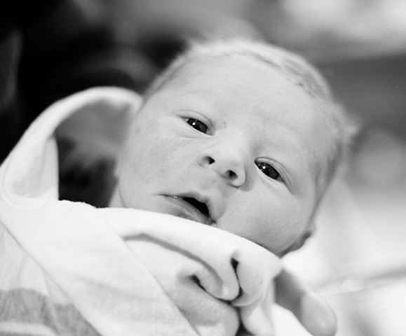 A newborn infant in a black and white photo -- the baby is named for the University of Cincinnati's standout football player Teddy Baehr.