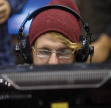 Gamer with his knit cap and headphones on.
