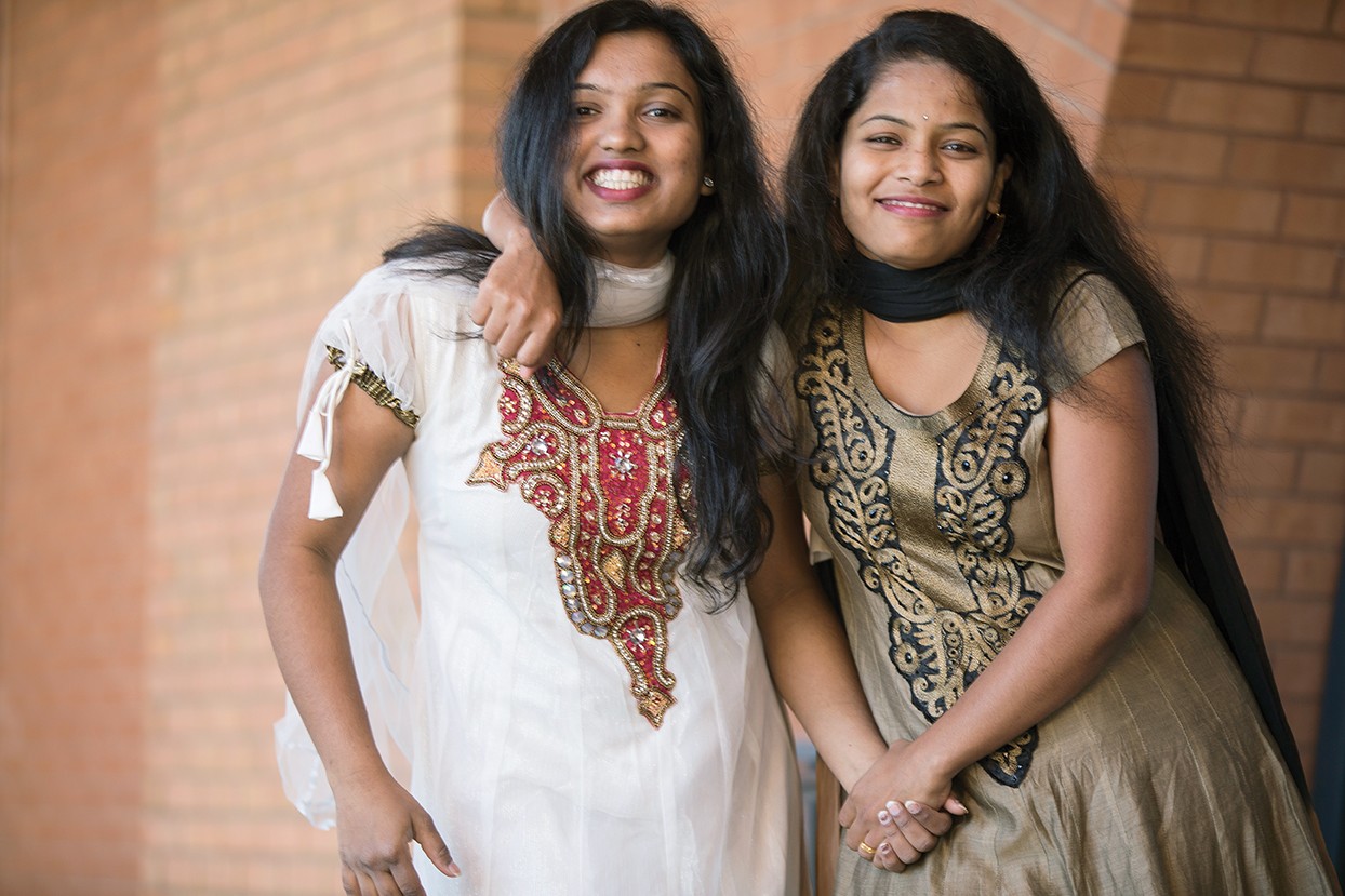 Karishma Randhave (left) and Anjani Lahane pose in their traditional Indian clothes outside UC's Engineering Research Center. 