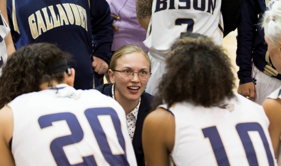 Gallaudet women's basketball coach Stephanie Stevens in the center of his team giving instructions.