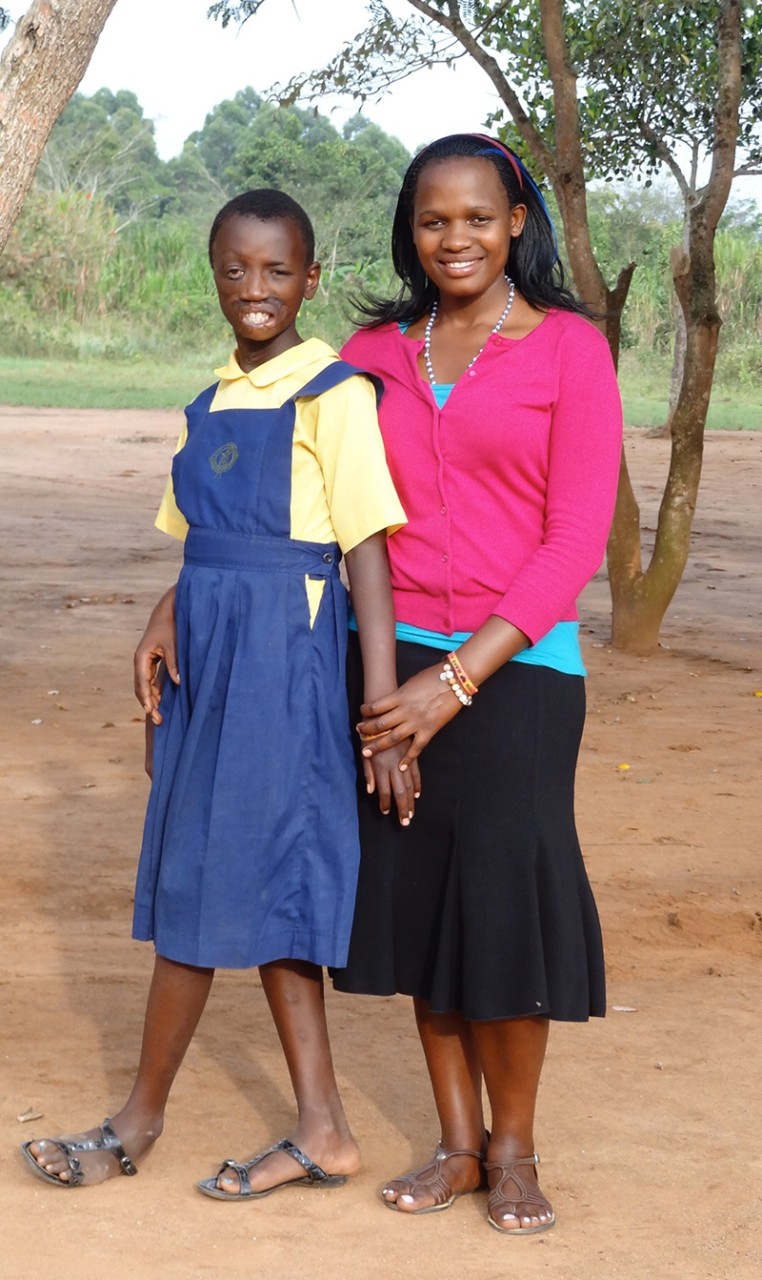 Maria Nakafeero stands with Mackline Tumusiime, a teenager from Uganda who came to Shriners Hospitals for Children to have reconstructive surgeries.