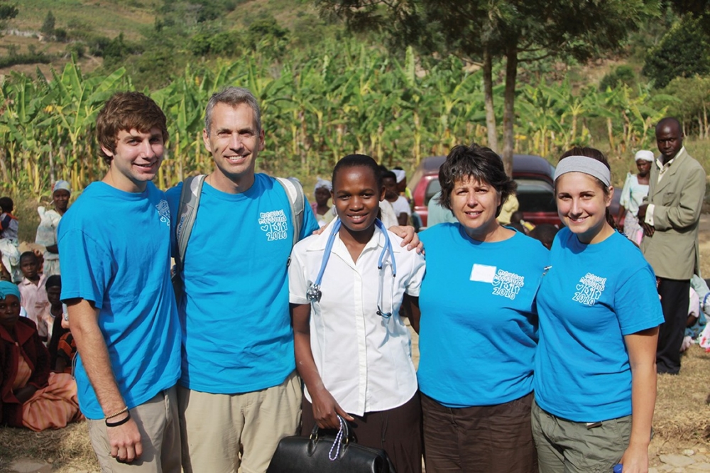 Maria Nakafeero spends time with volunteers from a medical mission trip in Kabingo, a small village in western Uganda.