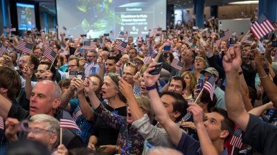 A large crows celebrates at the Johns Hopkins University Applied Physics lab