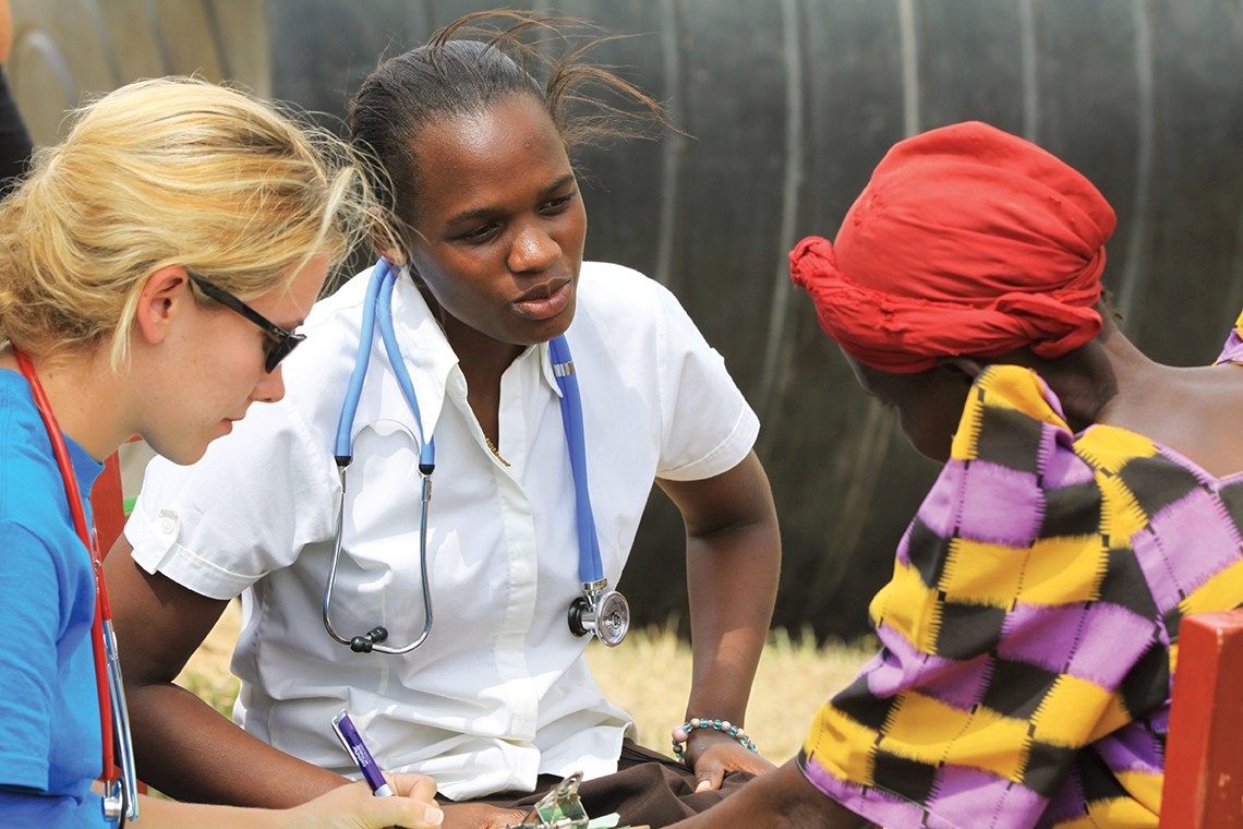Maria Nakafeero speaks to a patient in Uganda