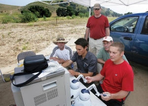 Assistant professor of surgery Timothy Broderick (far right), medical director for UC's Center for Surgical Innovation, and his team perform robotic telesurgery in a desolate valley in California on a simulated patient five miles away. In 2005, Dr. Broderick and his UC team used the da Vinci surgical robot to lead the nation's first live telesurgery from Ohio to California.  Photo/Reed Hutchison