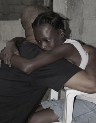 Cadet hugs a Haitian child living a life of servitude.