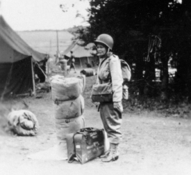 Beginning in May 1942, College of Medicine dean Stanley Dorst and colleagues selected physicians and nurses from the staff and graduates of the colleges of nursing and medicine to serve in the 25th. Here nurse Stella (last name unknown) prepares to leave England for France, "complete with 18-inch bedroll and helmet," as Ashbaugh described.