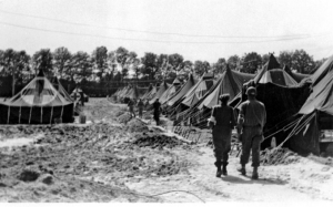 Setting up 529 tents on concrete bases to form a hospital in Lison, France, became difficult in August 1944 when continual rain created so much mud that trucks became trapped.