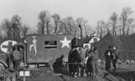 Ashbaugh helped acquire this French ambulance for the 25th at Lison and tried to find tires for it at the local junkyard.
