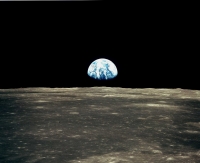 The Earth shown over the surface of the moon.