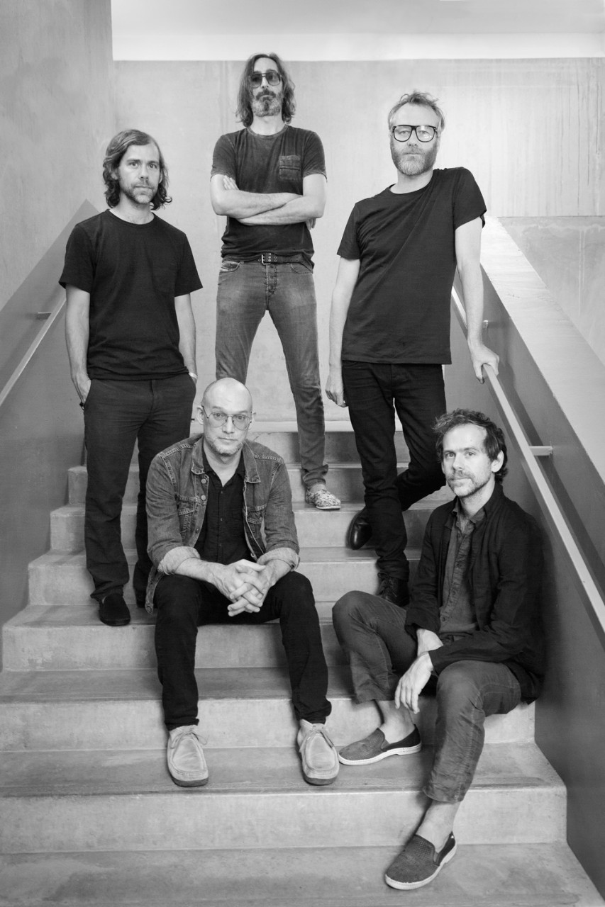 Members of The National pose in a stairwell