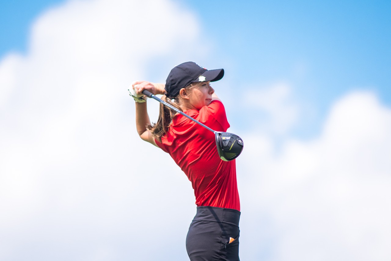 UC golfer Anika Hitt swings her club on the course