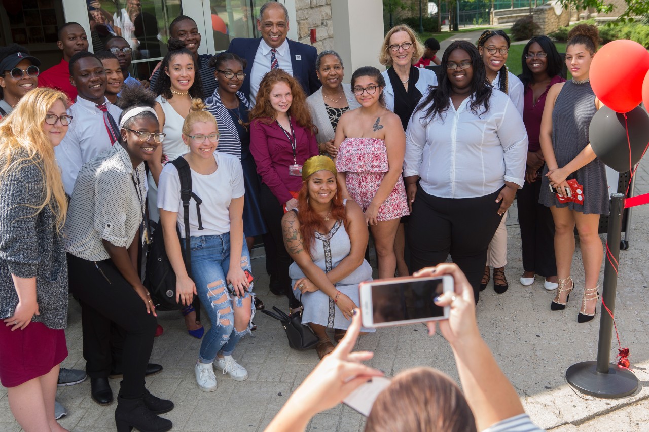 Members of the Gen-1 Theme House pose with UC's President Neville Pinto