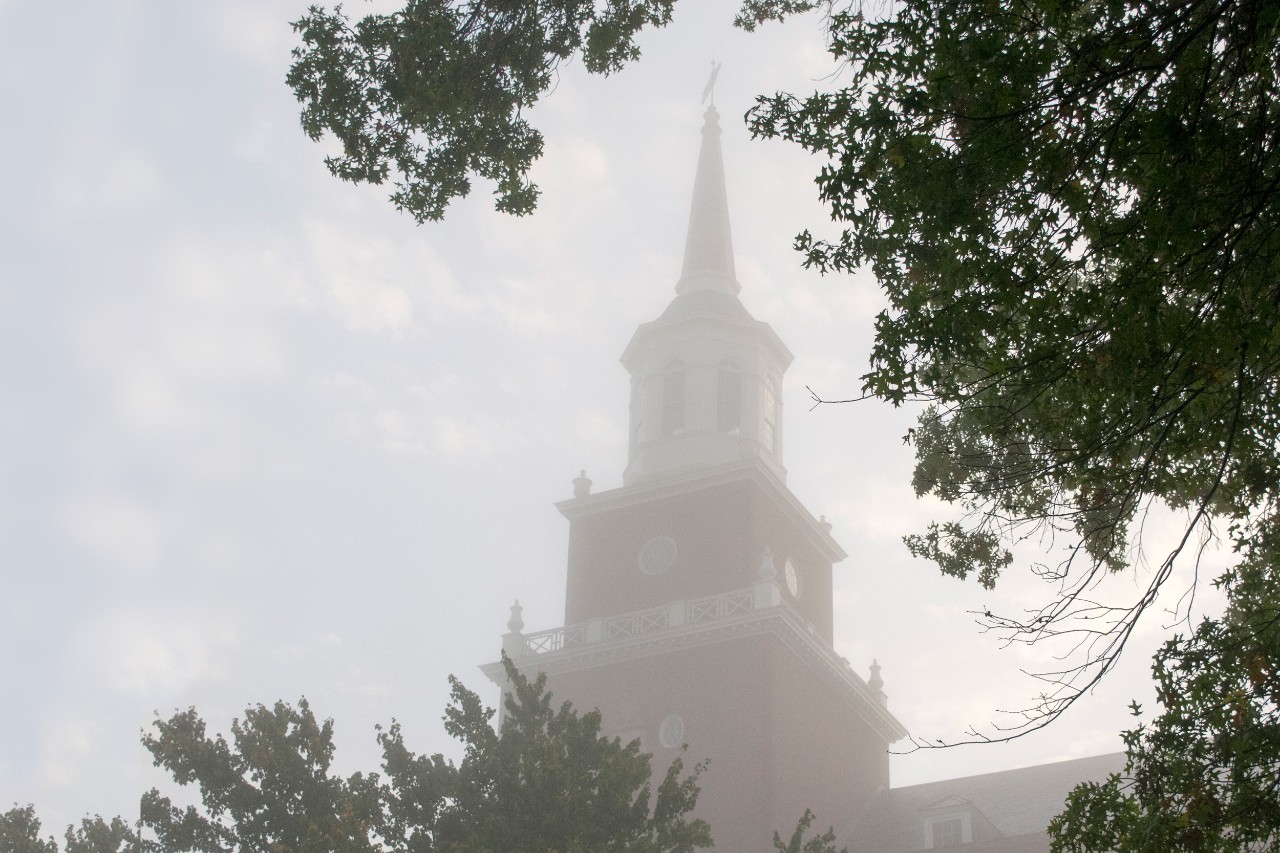 The spire of McMicken hall in a morning fog