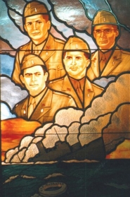 Stained glass window depicts head shots of each of the four chaplains.