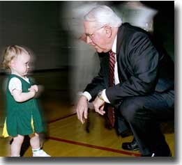 Even though Dr. Steger was walking into a press conference to accept a check for $10 million, he always has time for young people. While the donors for the new Varsity Village waited, he stooped to say hello to the event's youngest attendant, Addison Fagan, the toddler daughter of Tabby Fagan, UC's head coach for cheerleaders. photo/Lisa Ventre