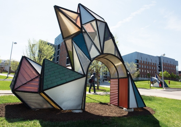 An outdoor sculpture called Crystal Garden looks like a stained glass window that's been shaped to a point.