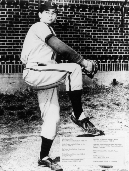 Black and white image captures Sandy Koufax at the University of Cincinnati as he pitches.