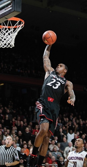UC's Sean Kilpatrick jumps to dunk the basketball.