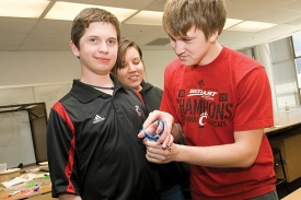 UC engineering students Jake Turner and JosiHerren with 14-year-old Ryan Korengel