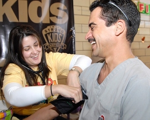 Margie Gerena-Lewis, UC professor of hematology oncology, checks the blood pressure of Eric Lopez