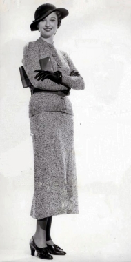 Venable wearing a smart skirted suit and hat