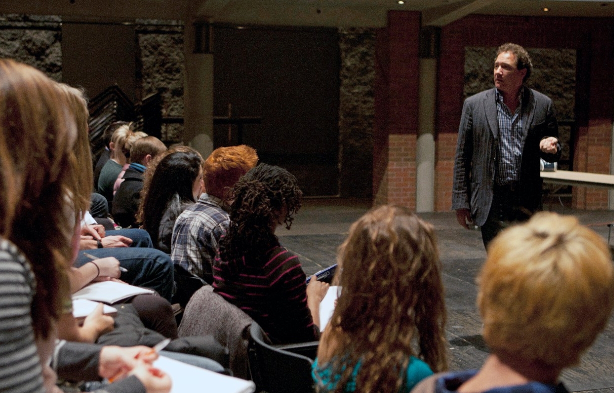 Broadway producer and UC alum Kevin McCollum paces and lectures to an audience of students from UC's College-Conservatory of Music.