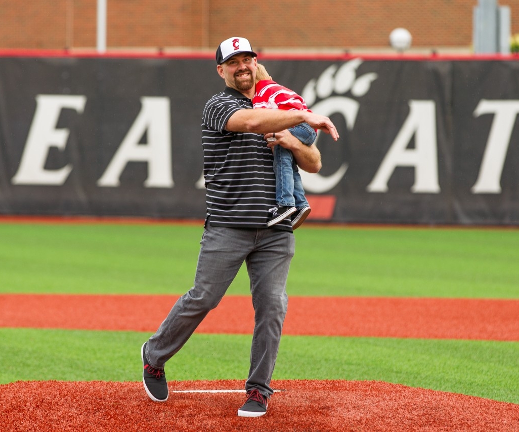 Former University of Cincinnati baseball player and major leaguer Kevin Youkilis throws a ceremonial first pitch.