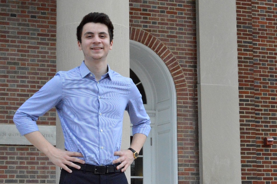 The second youngest graduate of the University of Cincinnati, Ismail Gunacar, smiles for the camera.