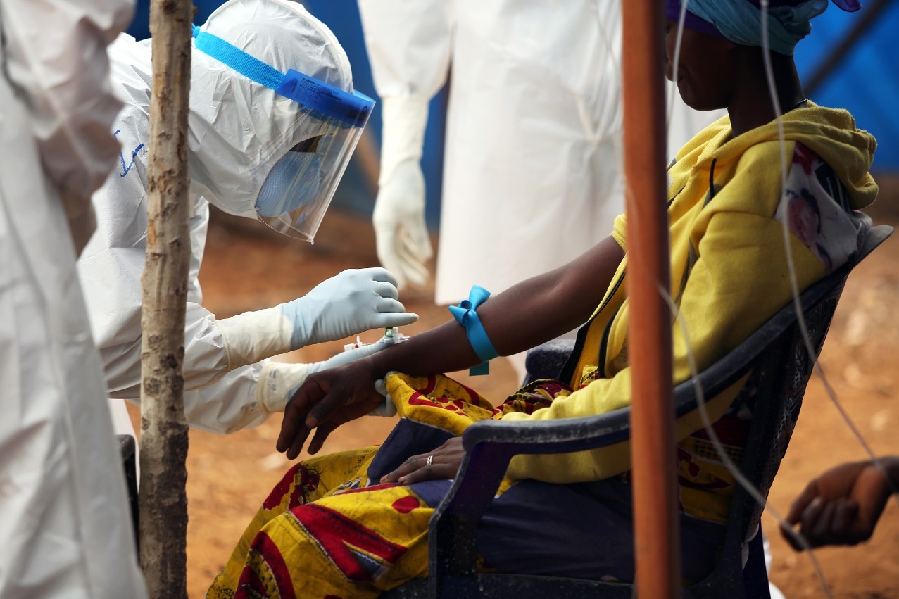 A volunteer from Partners in Health treats a patient in the Maforki Ebola Treatment Unit in Sierra Leone.