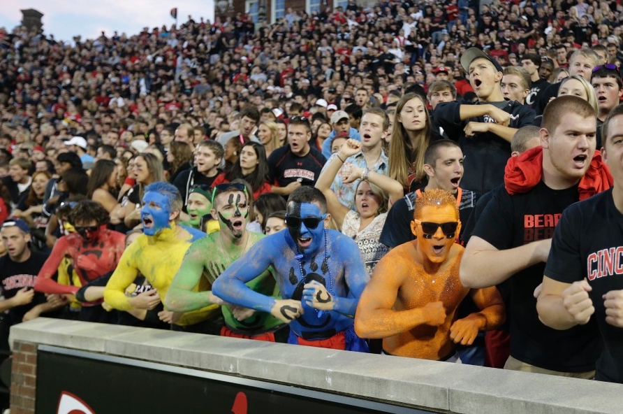 Crazy painted University of Cincinnati students perform a cheer called Down the Drive.