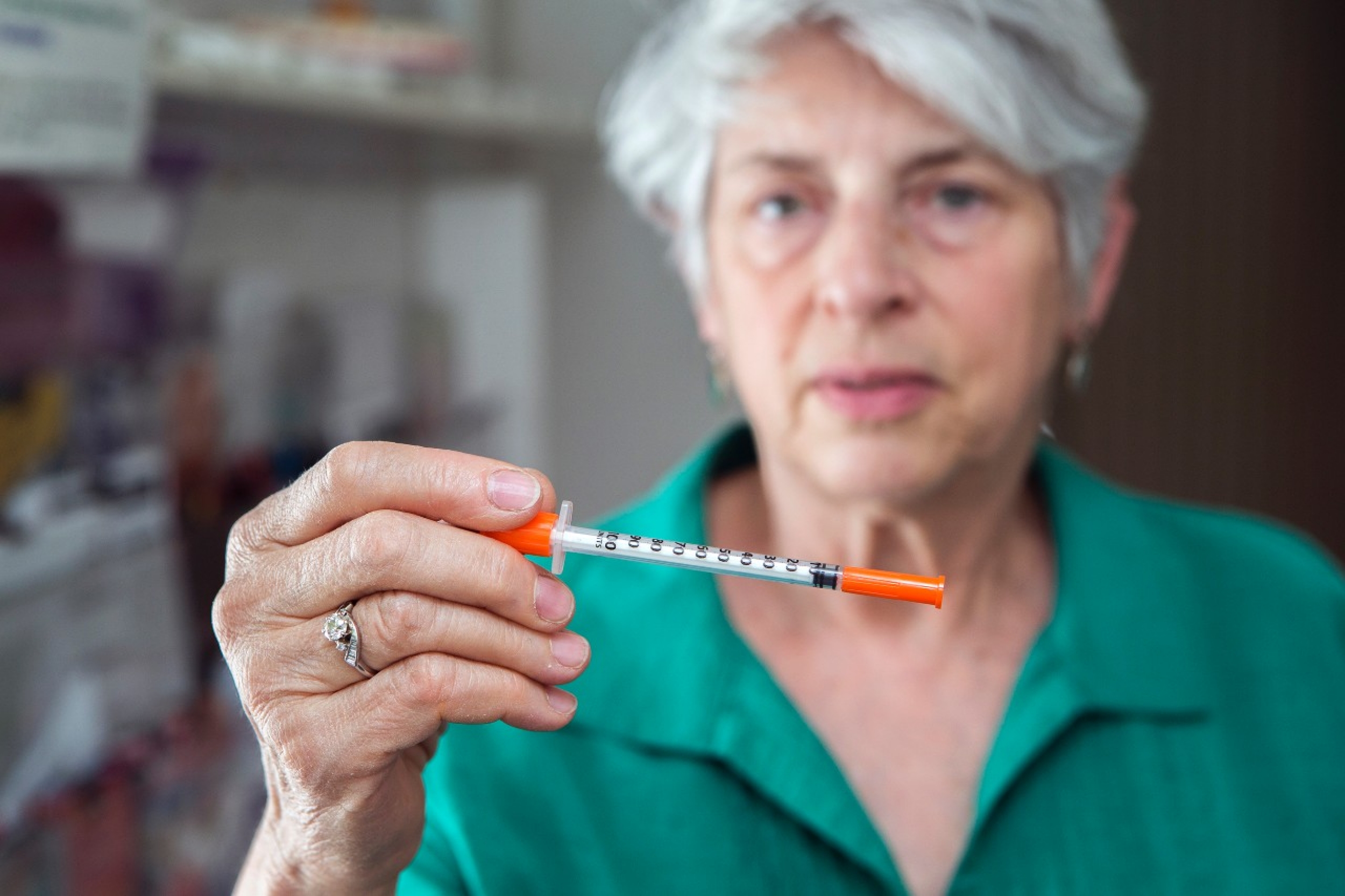 Dr. Feinberg holds a needle. 